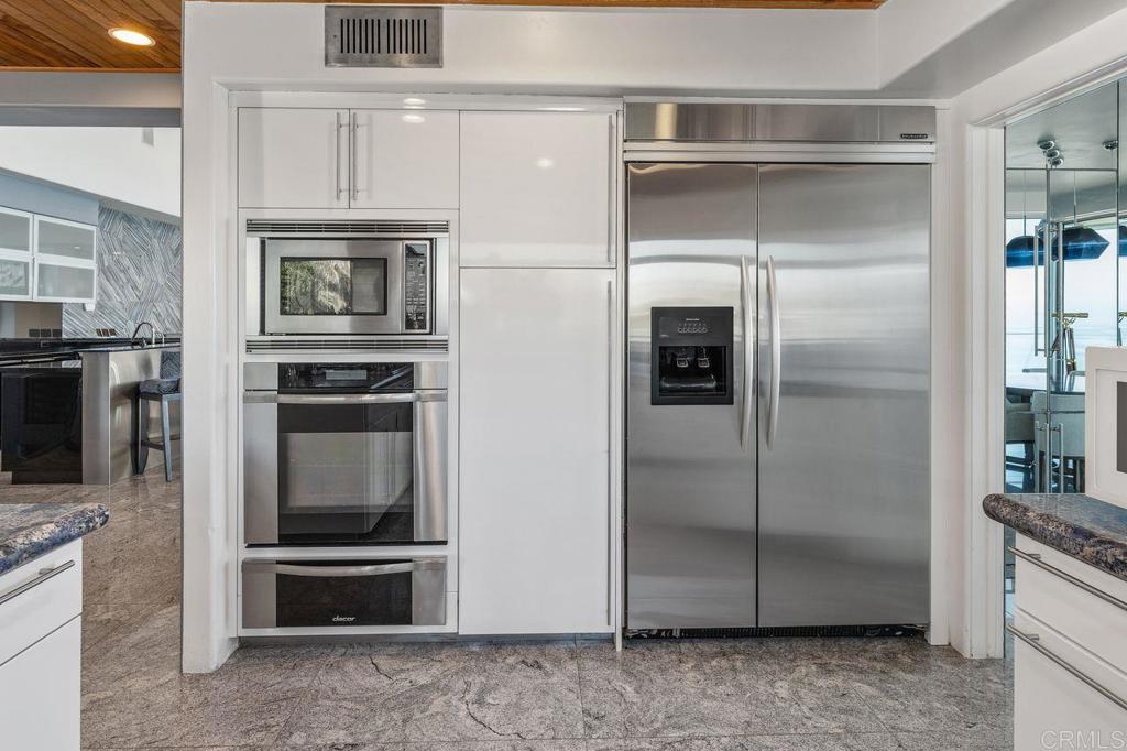 806 4th Street Encinitas, CA 92024 - Photo 23 of 47 a kitchen with cabinets and stainless steel appliances