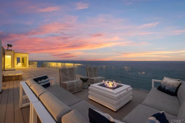 a view of a terrace with couches and sky view