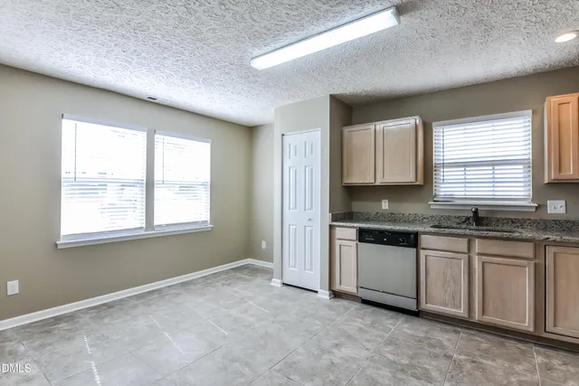 a view of a kitchen with granite countertop cabinets and stainless steel appliances