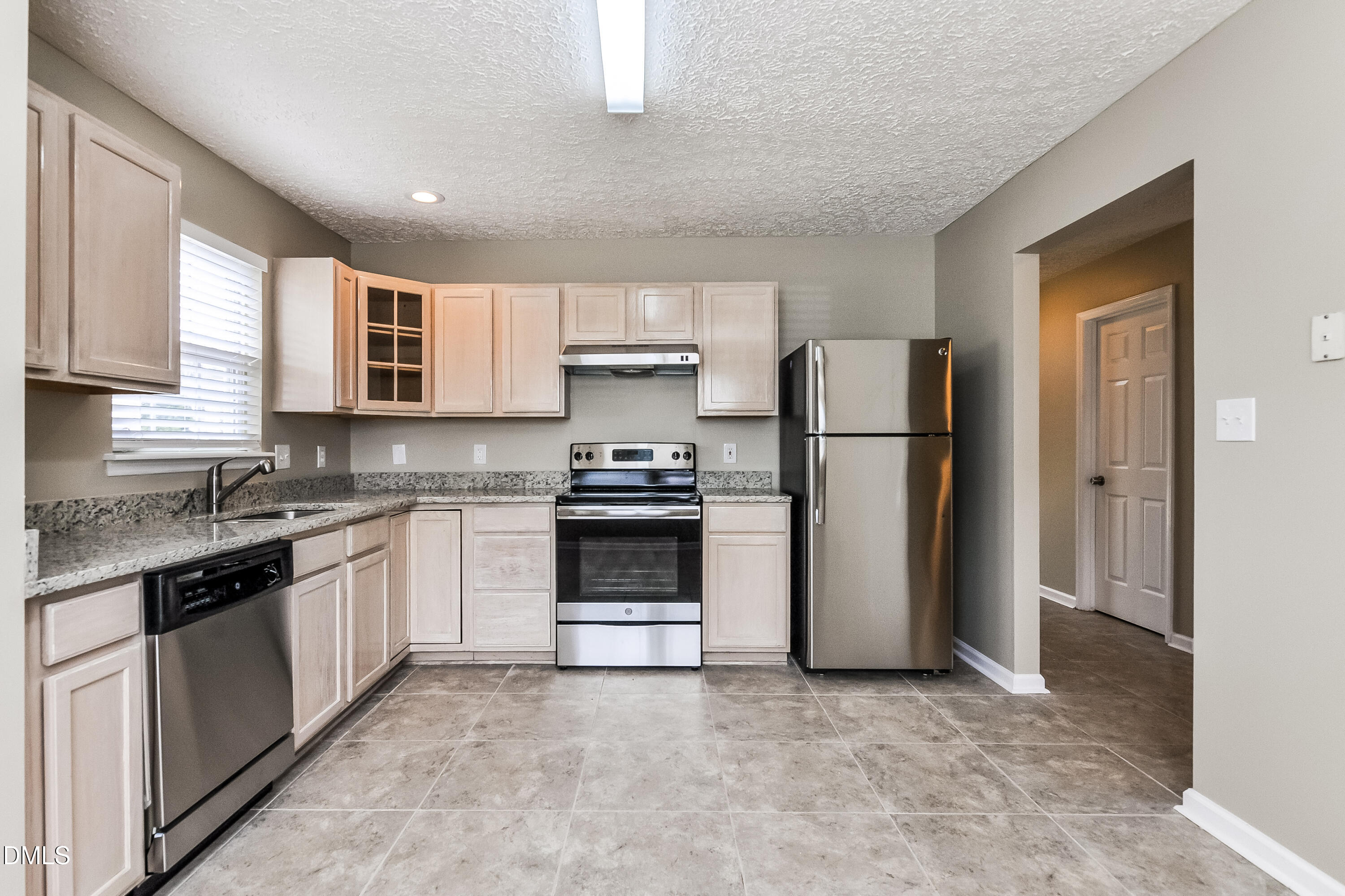 3619 Sana Court Durham, NC 27713 - Photo 8 of 15 a kitchen with a refrigerator sink and stove top oven