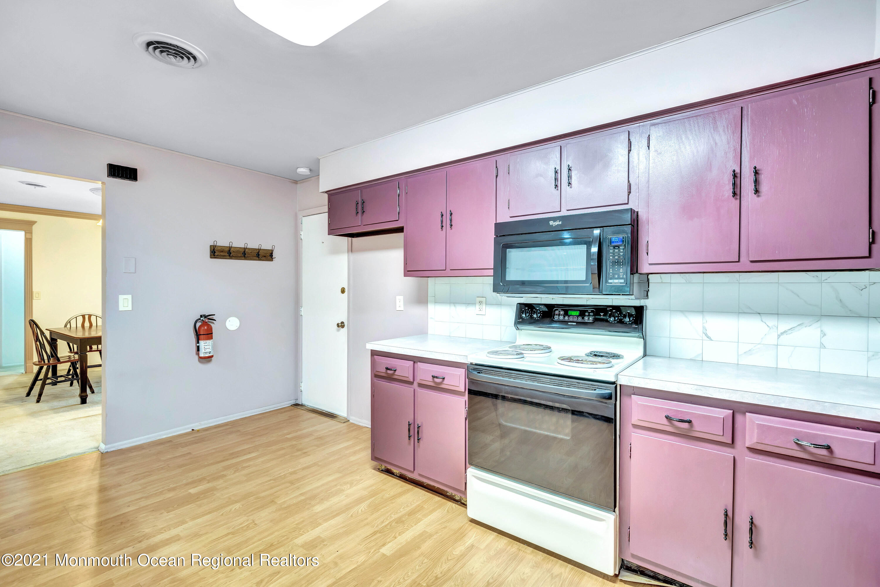 105 Georgetown Road Toms River, NJ 08757 - Photo 20 of 35 a kitchen with stainless steel appliances white cabinets and wooden floor