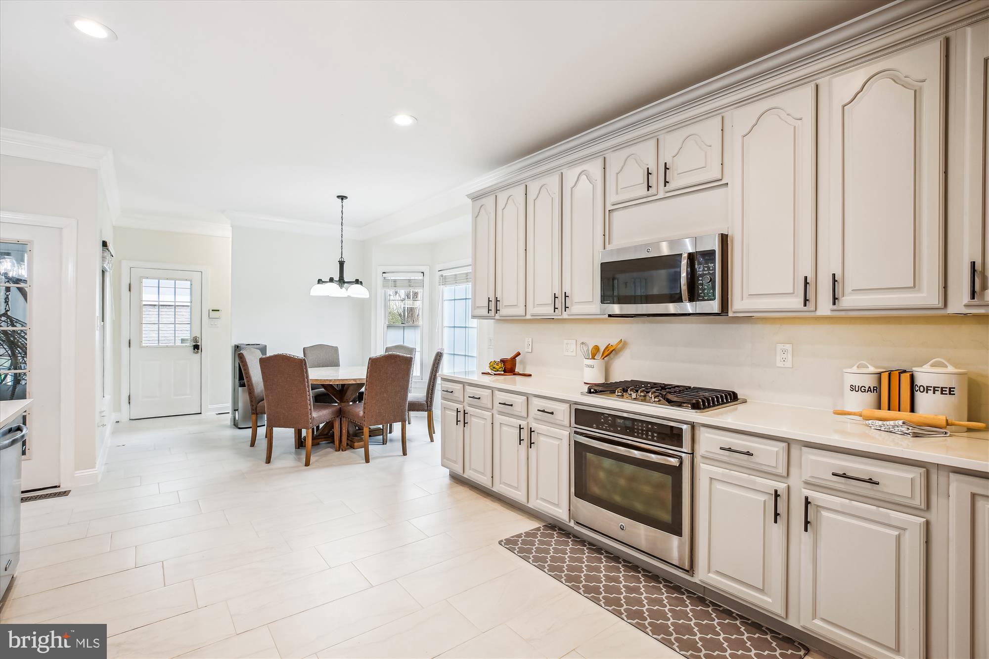 302 Tschiffely Square Road Gaithersburg, MD 20878 - Photo 16 of 77 a kitchen with white cabinets and stainless steel appliances