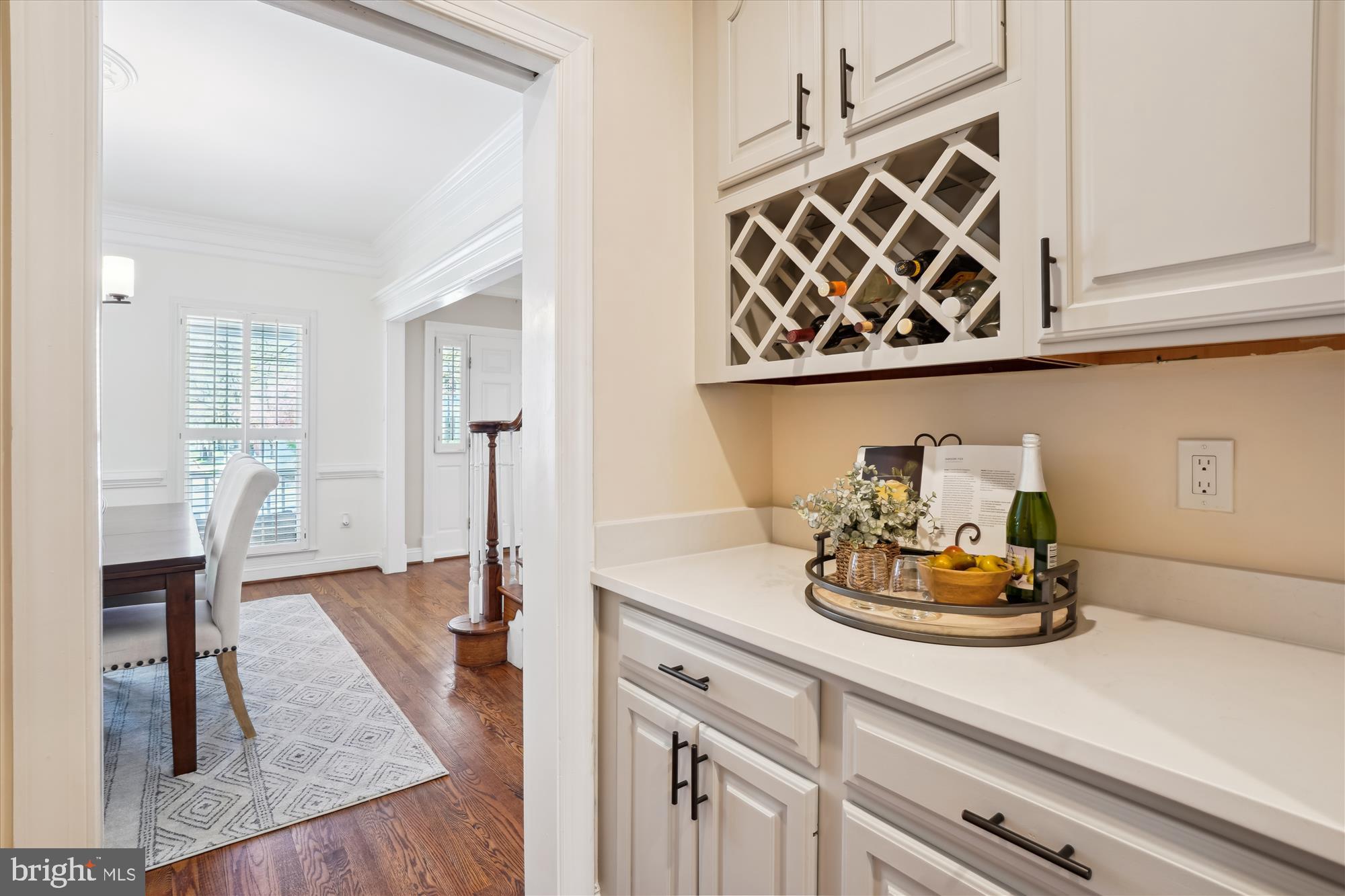 302 Tschiffely Square Road Gaithersburg, MD 20878 - Photo 19 of 77 a kitchen with a wooden floor and cabinets