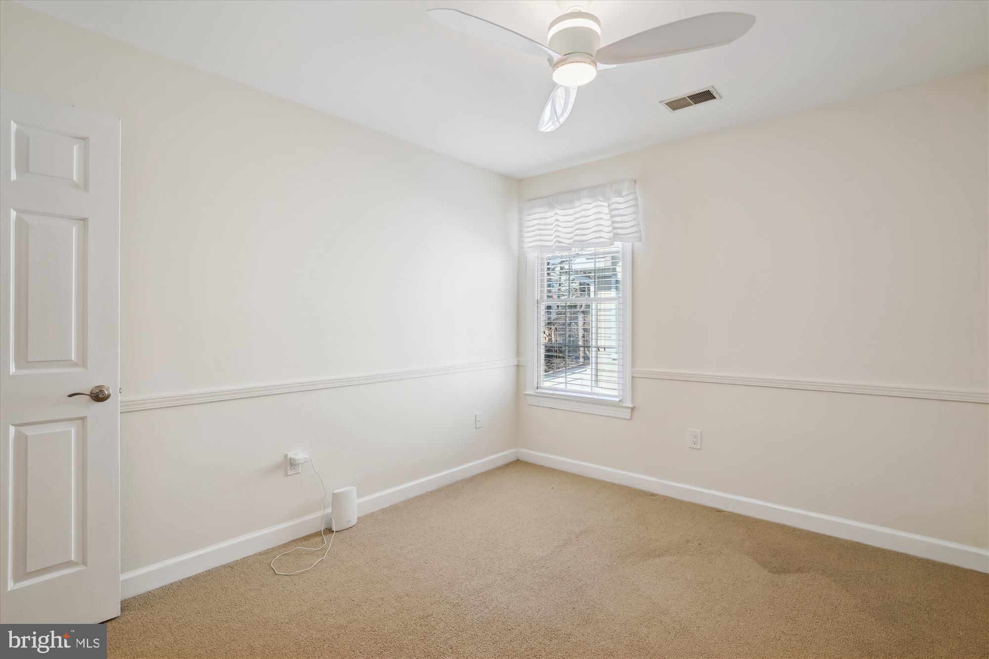 302 Tschiffely Square Road Gaithersburg, MD 20878 - Photo 43 of 77 an empty room with a window and ceiling fan