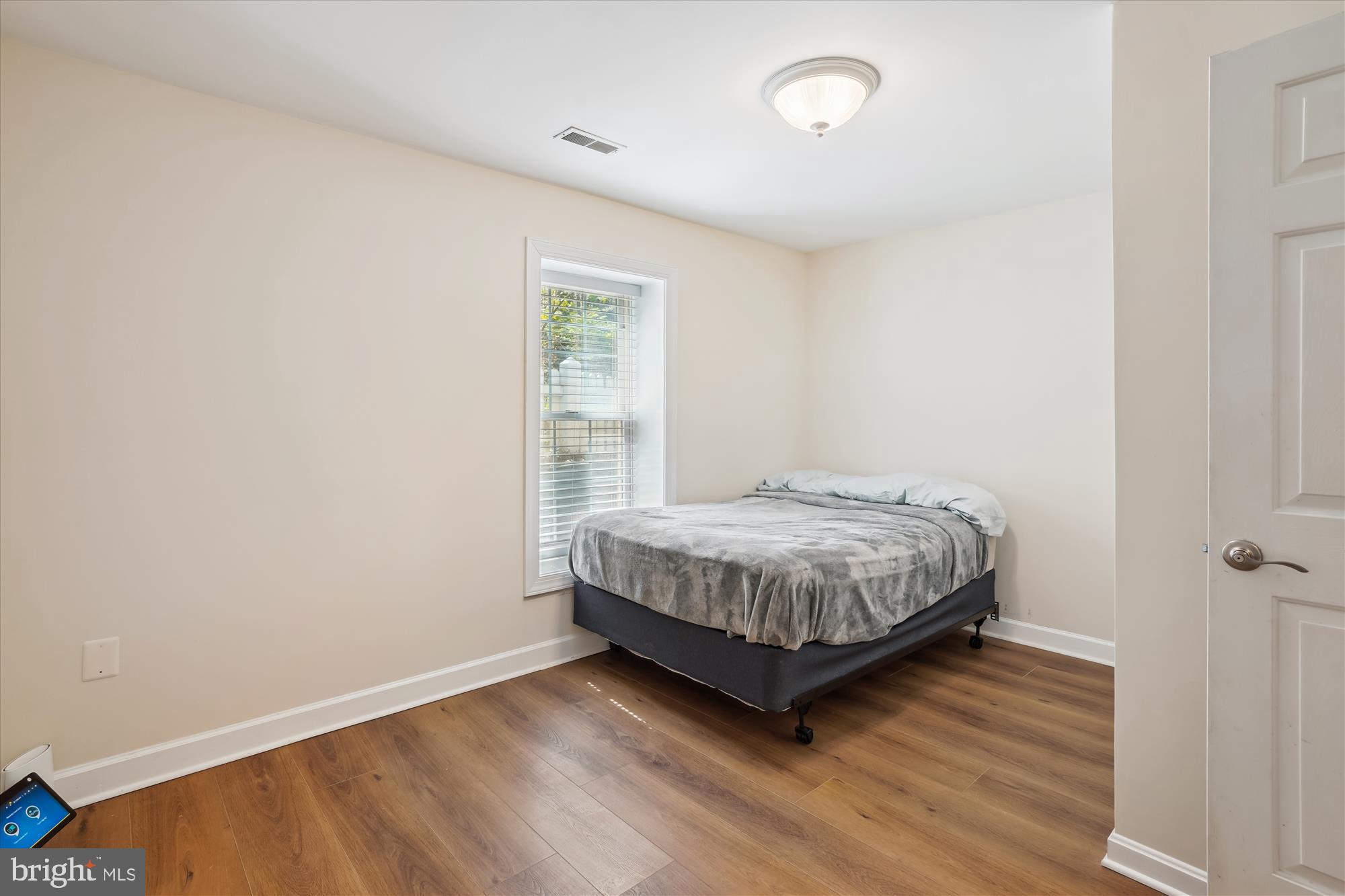 302 Tschiffely Square Road Gaithersburg, MD 20878 - Photo 53 of 77 a bedroom with a bed and wooden floor