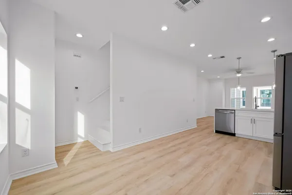 a room with wooden floor and window