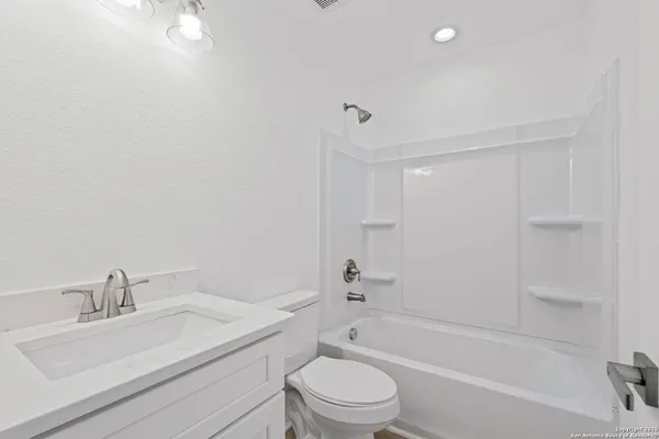 a bathroom with a sink toilet and bathtub
