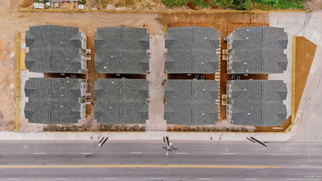 an aerial view of a house with a yard and lake view