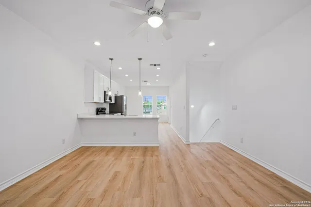 a view of kitchen with sink and wooden floor