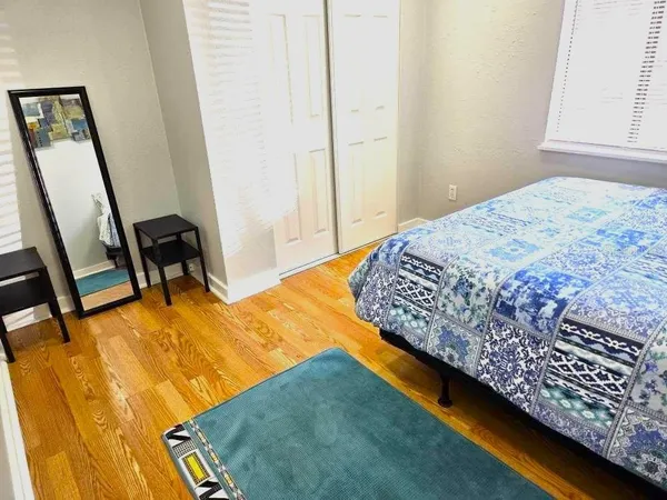 a bedroom with a bed and a window