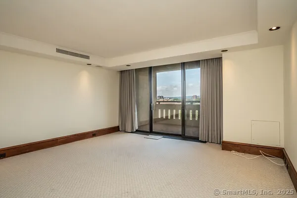 a view of an empty room with windows