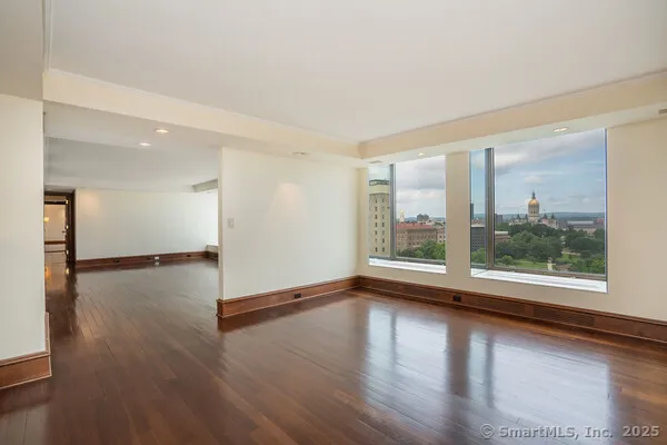 a view of a room with wooden floor and window