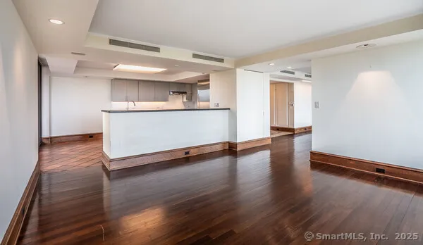 a view of a room with wooden floor and window