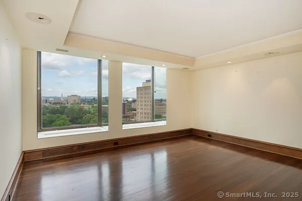 a view of a room with wooden floor and window