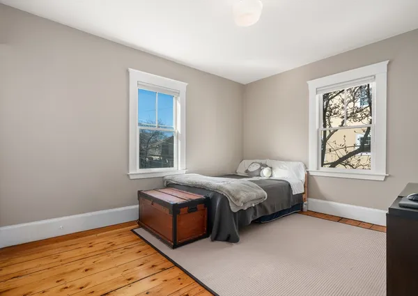 a bed sitting in a bedroom next to a window