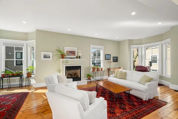 a living room with furniture a fireplace and a table