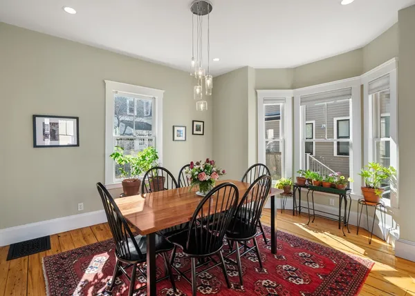 a view of a dining room with furniture window and wooden floor