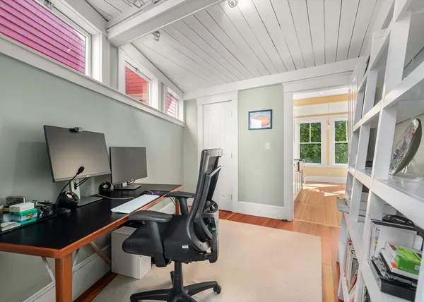 a view of a workspace with furniture and a window