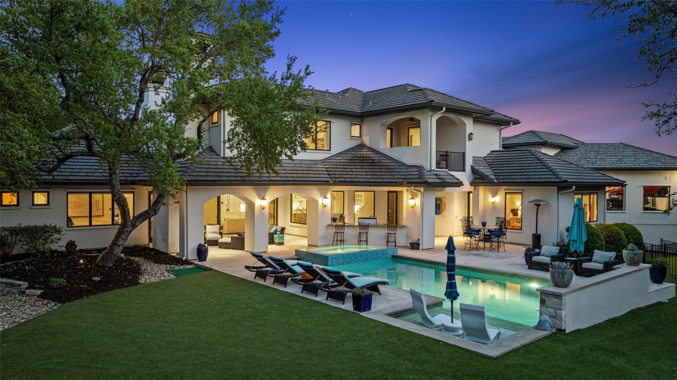 a view of a house with swimming pool and sitting area