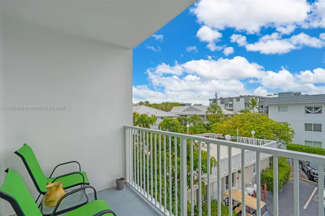 a view of a balcony with wooden floor and fence