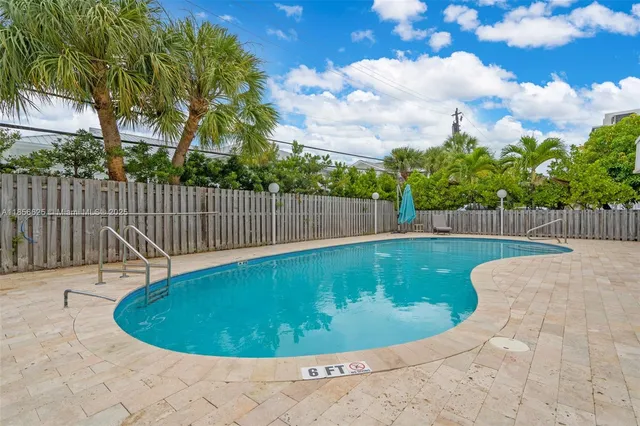 a swimming pool with wooden fence