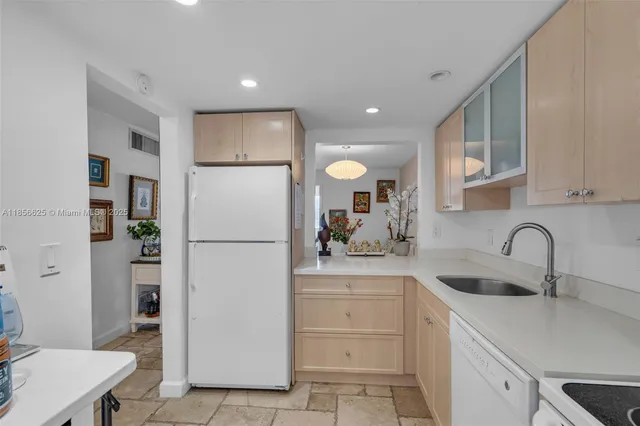 a white refrigerator freezer sitting in a kitchen