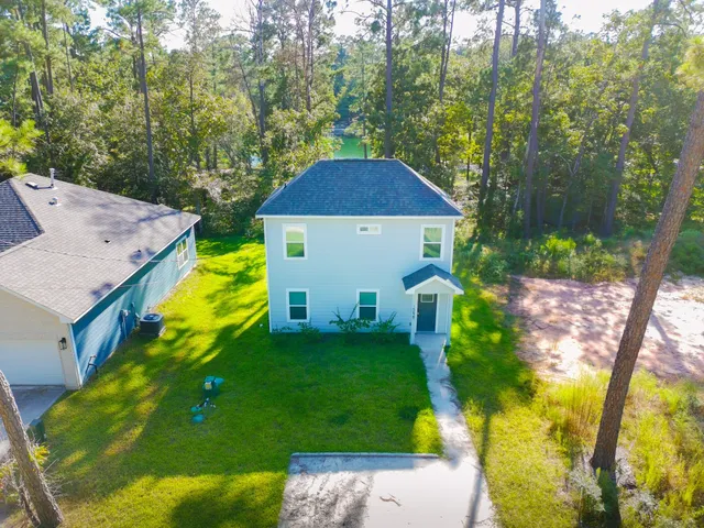 a view of a house with a yard and sitting area