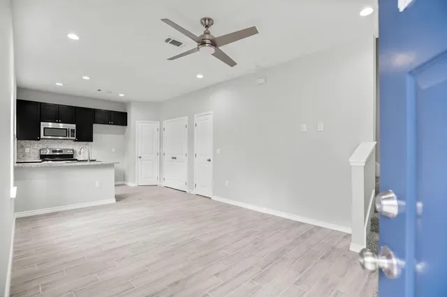 a view of kitchen with microwave and wooden floor