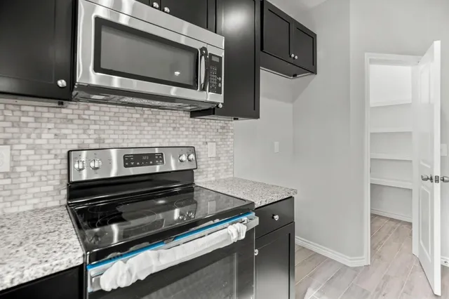a kitchen with a stove microwave and sink