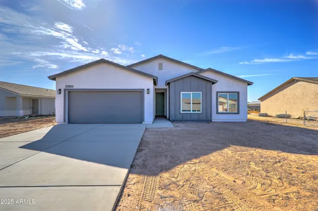 a view of a house with a yard and garage