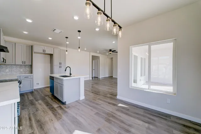 a view of a kitchen with wooden floor and a window