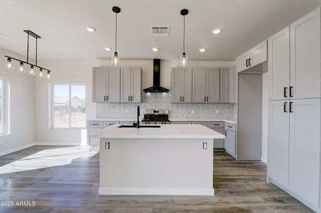 a kitchen with kitchen island white cabinets and white appliances