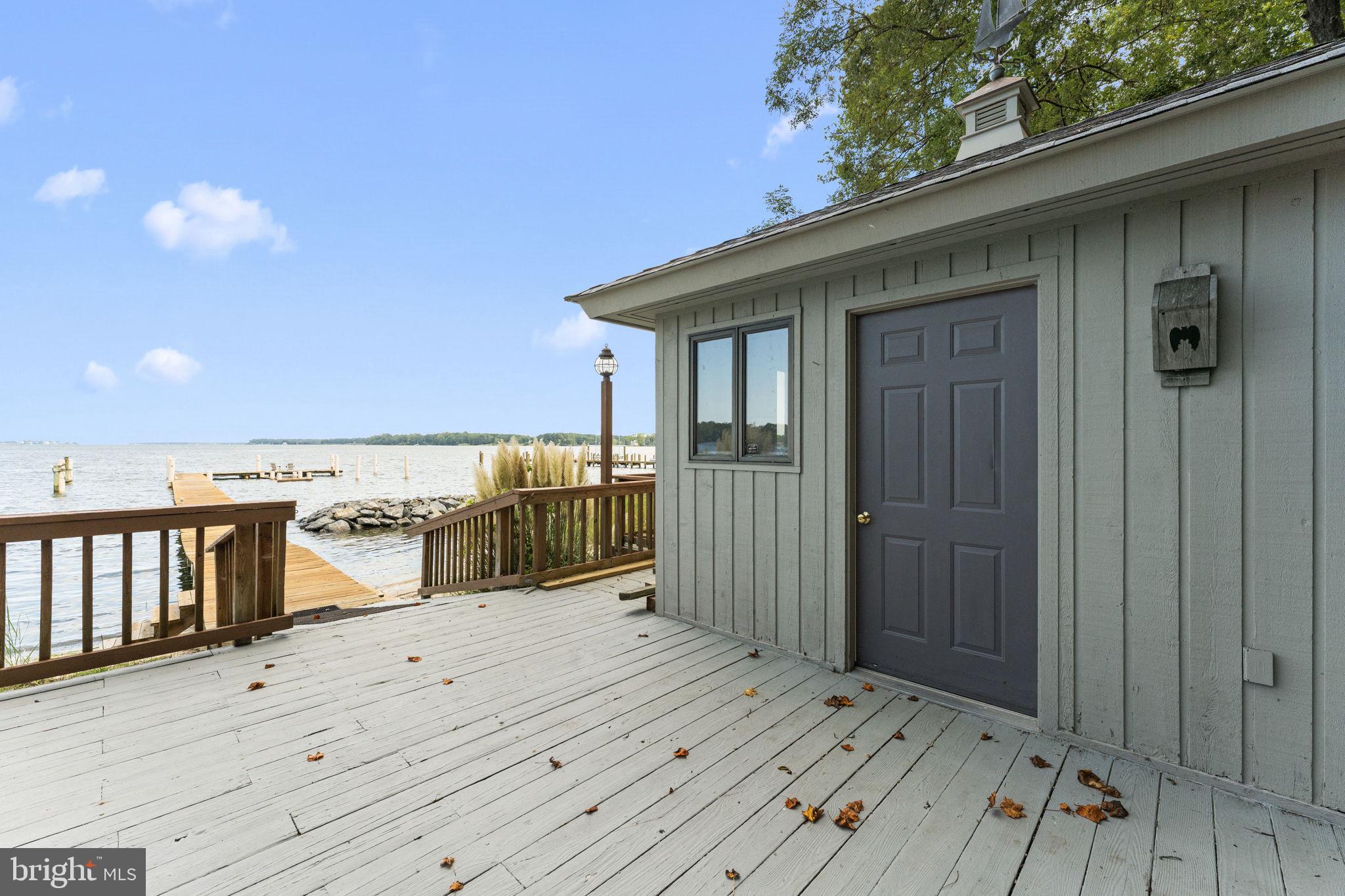 975 Wilton Creek Road Hartfield, VA 23071 - Photo 12 of 33 a view of a balcony with wooden floor and seating space