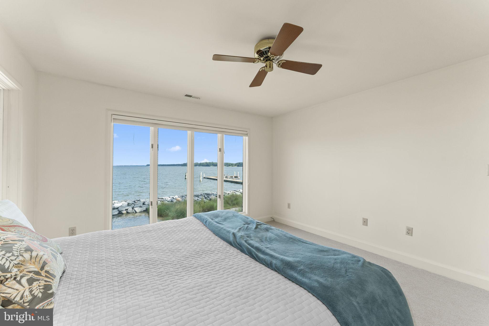 975 Wilton Creek Road Hartfield, VA 23071 - Photo 21 of 33 a bedroom with a bed and a window