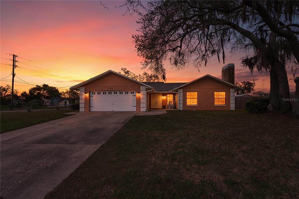 3112 Polk Avenue Spring Hill, FL 34609 - Photo 1 of 50 a front view of a house with a yard