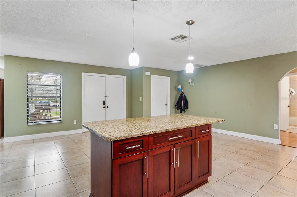 3112 Polk Avenue Spring Hill, FL 34609 - Photo 11 of 50 a spacious bathroom with a granite countertop sink a mirror and a vanity