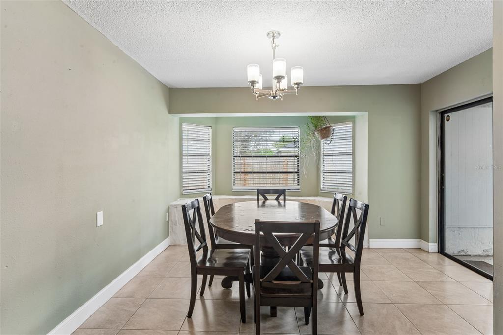 3112 Polk Avenue Spring Hill, FL 34609 - Photo 12 of 50 a view of a dining room with furniture and chandelier