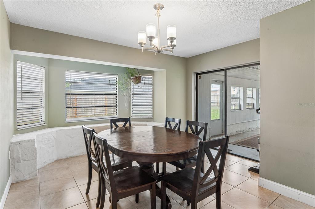 3112 Polk Avenue Spring Hill, FL 34609 - Photo 13 of 50 a view of a dining room with furniture and window