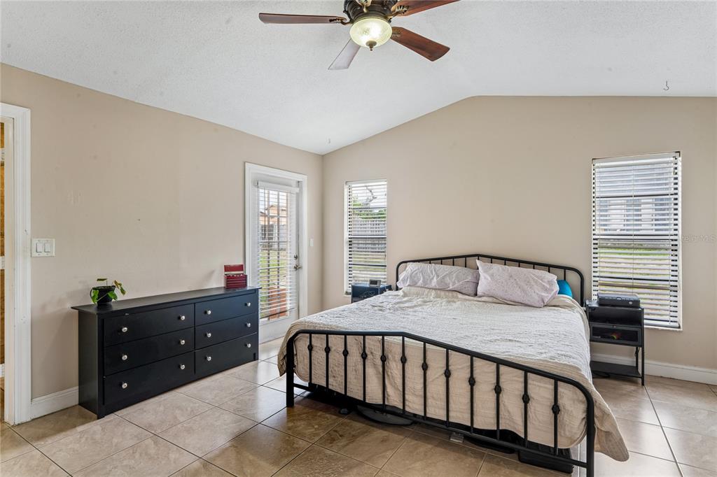 3112 Polk Avenue Spring Hill, FL 34609 - Photo 18 of 50 a bedroom with a bed and a chandelier