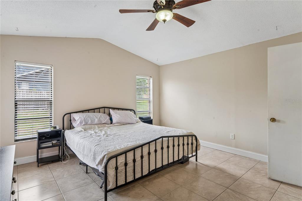 3112 Polk Avenue Spring Hill, FL 34609 - Photo 19 of 50 a bed sitting in a bedroom next to a window