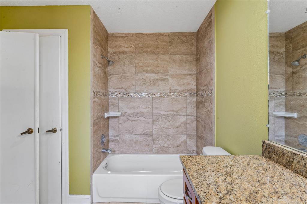 3112 Polk Avenue Spring Hill, FL 34609 - Photo 22 of 50 a bathroom with a bathtub and shower