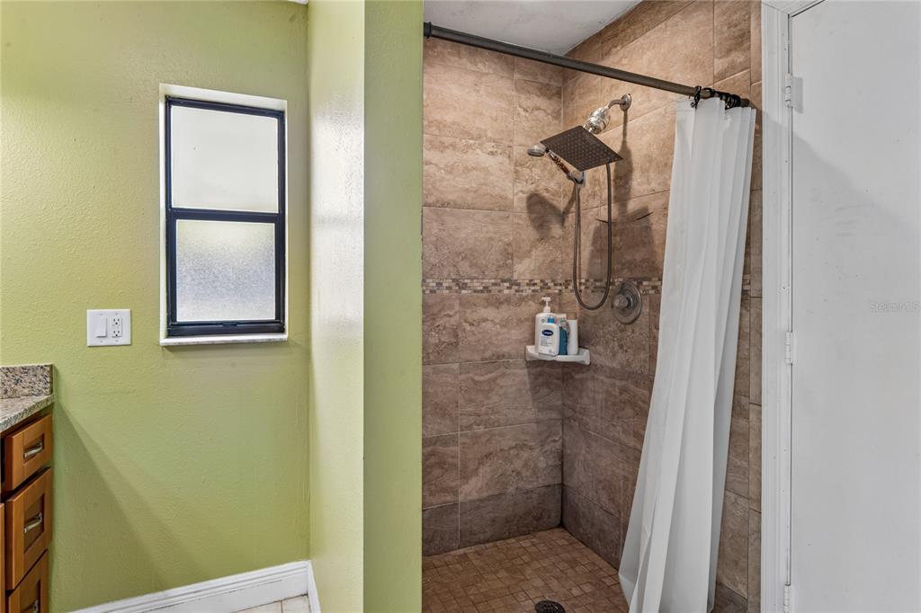 3112 Polk Avenue Spring Hill, FL 34609 - Photo 23 of 50 a bathroom with a shower