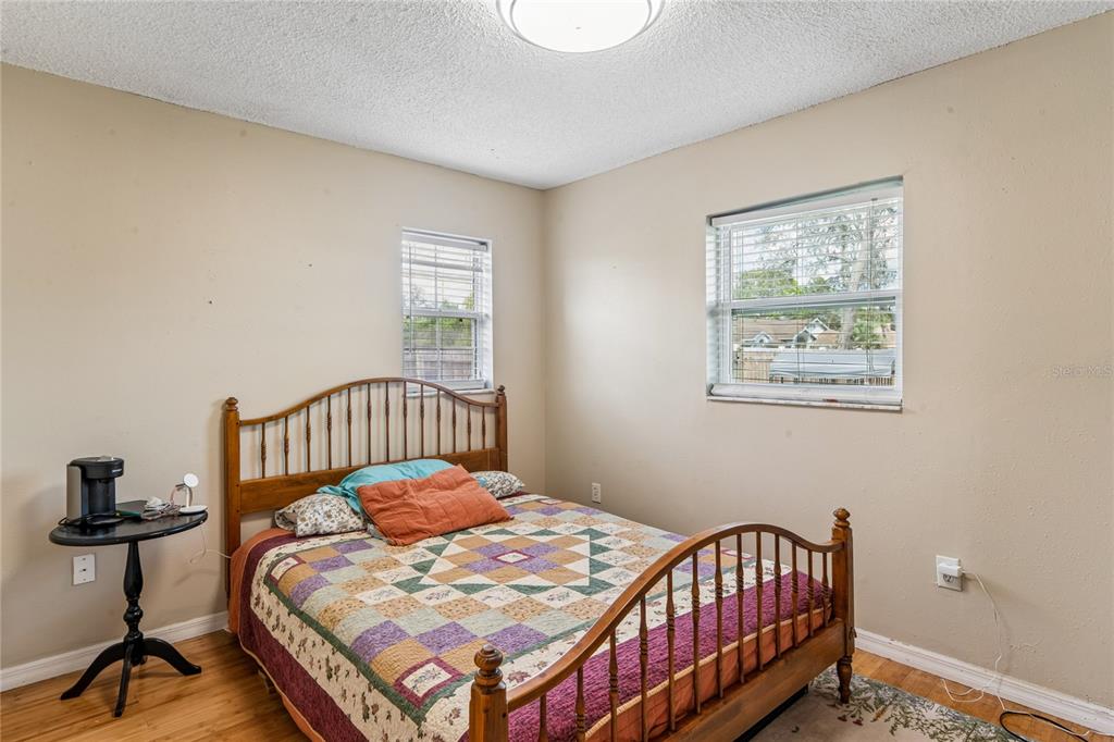 3112 Polk Avenue Spring Hill, FL 34609 - Photo 24 of 50 a bedroom with a bed window and a table in it