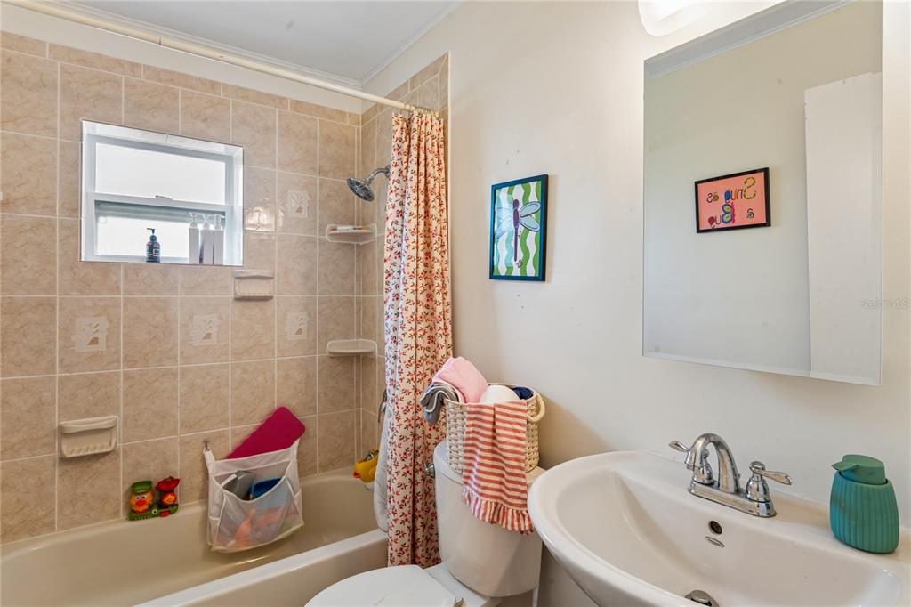 3112 Polk Avenue Spring Hill, FL 34609 - Photo 27 of 50 a bathroom with a sink and a toilet