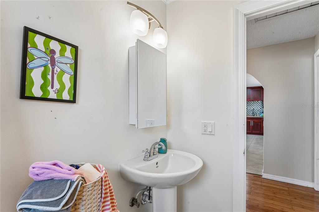 3112 Polk Avenue Spring Hill, FL 34609 - Photo 28 of 50 a bathroom with a sink and a mirror
