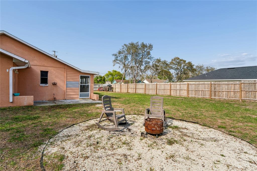 3112 Polk Avenue Spring Hill, FL 34609 - Photo 40 of 50 a view of a backyard with chair and garden