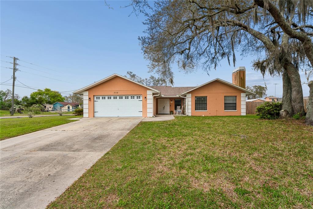 3112 Polk Avenue Spring Hill, FL 34609 - Photo 41 of 50 a view of a house with a yard and garage