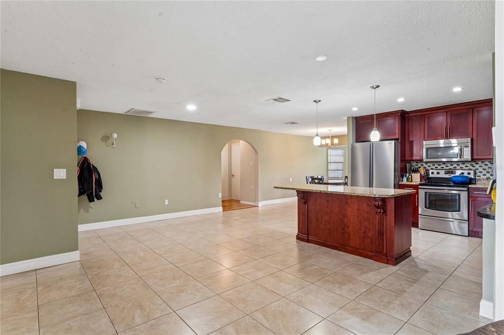 3112 Polk Avenue Spring Hill, FL 34609 - Photo 5 of 50 a view of kitchen with stainless steel appliances granite countertop a refrigerator and a stove top oven