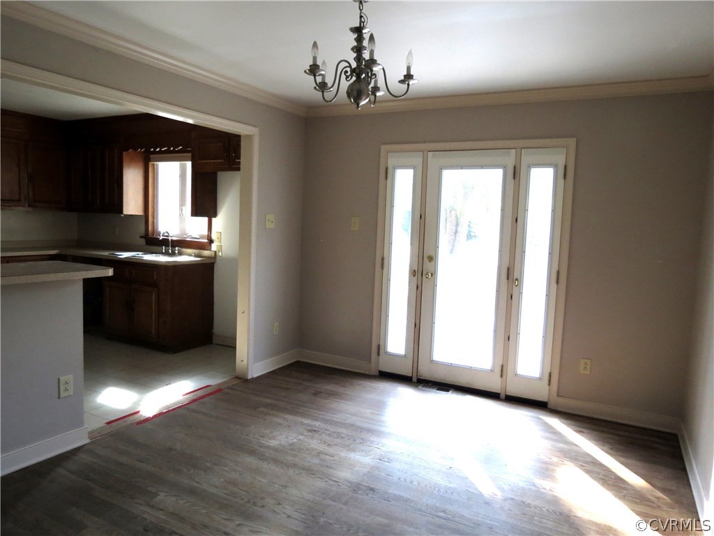 10810 Surry Road Chester, VA 23831 - Photo 14 of 24 a view of a kitchen with wooden floor and stainless steel appliances