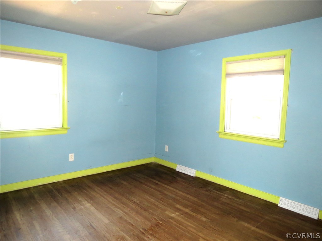 10810 Surry Road Chester, VA 23831 - Photo 18 of 24 a room with a wooden floor and a window